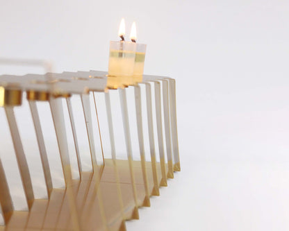 Gold Hanukkiah at an angle with two lit candles 
