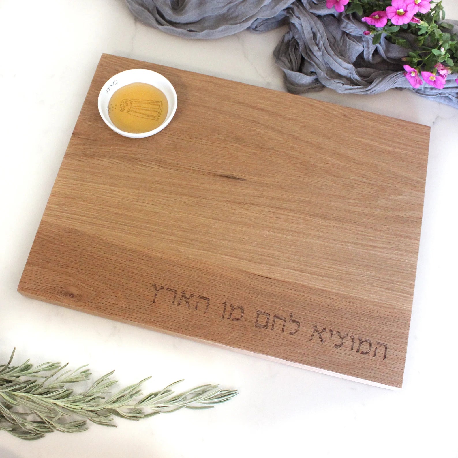 Oak Challah Board with a porcelain bowl which features an illustration of a blue and white salt shaker with honey in the bowl