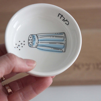 Porcelain bowl featuring an illustration of a blue and white salt shaker