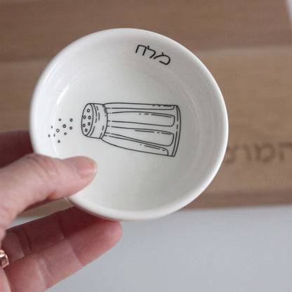 Porcelain bowl featuring an illustration of a black and white salt shaker