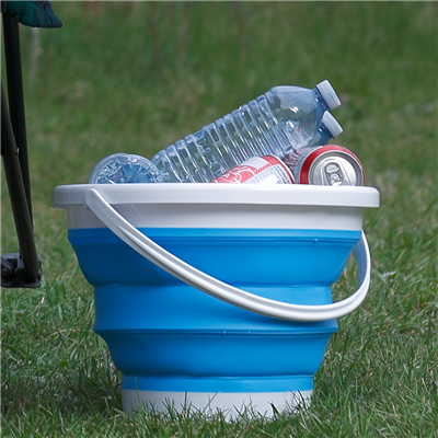 Expanded bucket sitting in the grass full of beverages