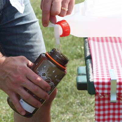 2-Gallon Expandable Water Carrier dispensing water into a bottle