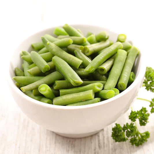 green beans in white bowl with cilantro garnish on the side 