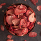 freeze dried strawberries overflowing in wooden dish