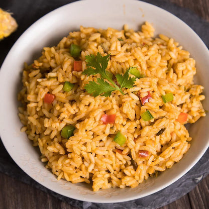 southwest rice with cilantro garnish on top in white bowl 