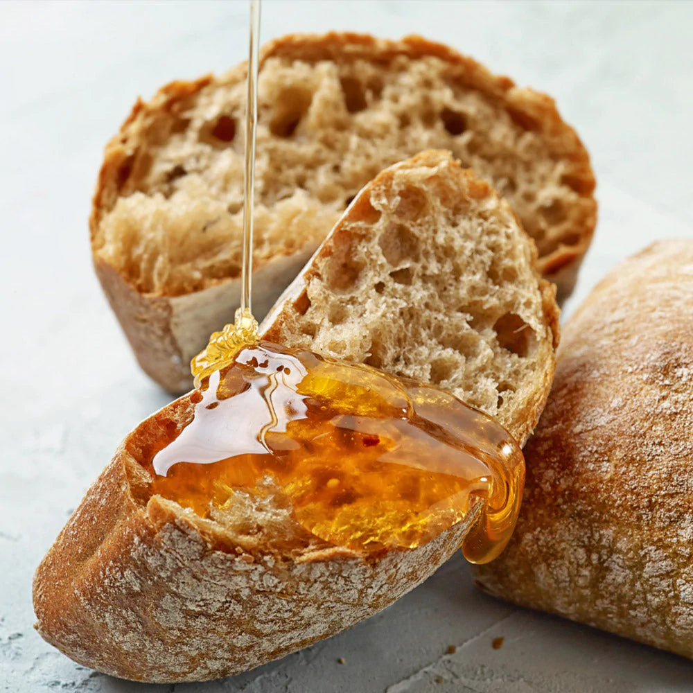 honey wheat loaf of bread drizzled in honey