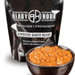 ready hour individual barbeque baked beans pack in black behind cooked baked beans in brown dish