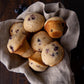 seven blueberry breakfast muffins wrapped in grey cloth 