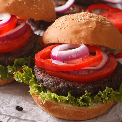 black bean burger patty on traditional bun with lettuce tomato and onion