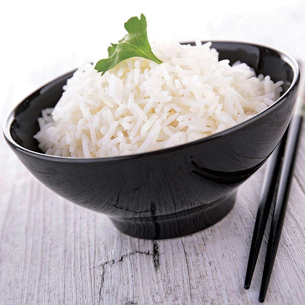 long grain white rice with green herb garnish on top and black chopsticks on the right side 
