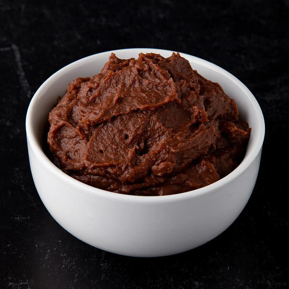 thick chocolate pudding in white bowl 
