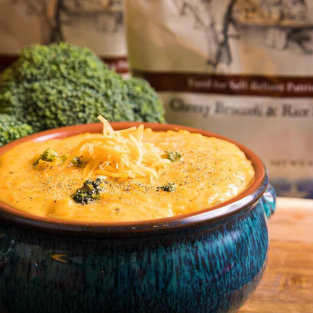 Cheesy Broccoli & Rice Soup in a blue and black ceramic bowl
