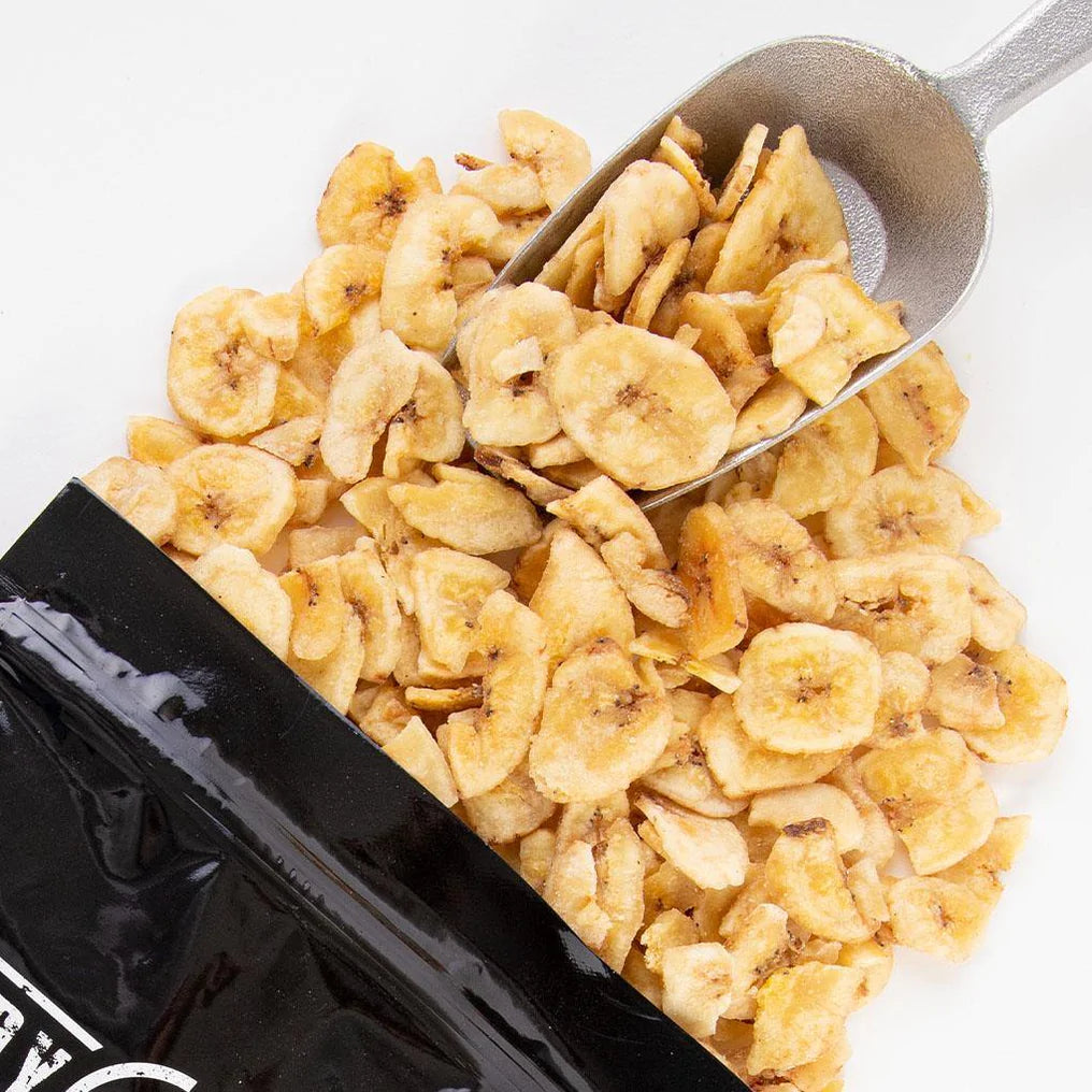 banana chips scooped out of individual pack by silver scoop