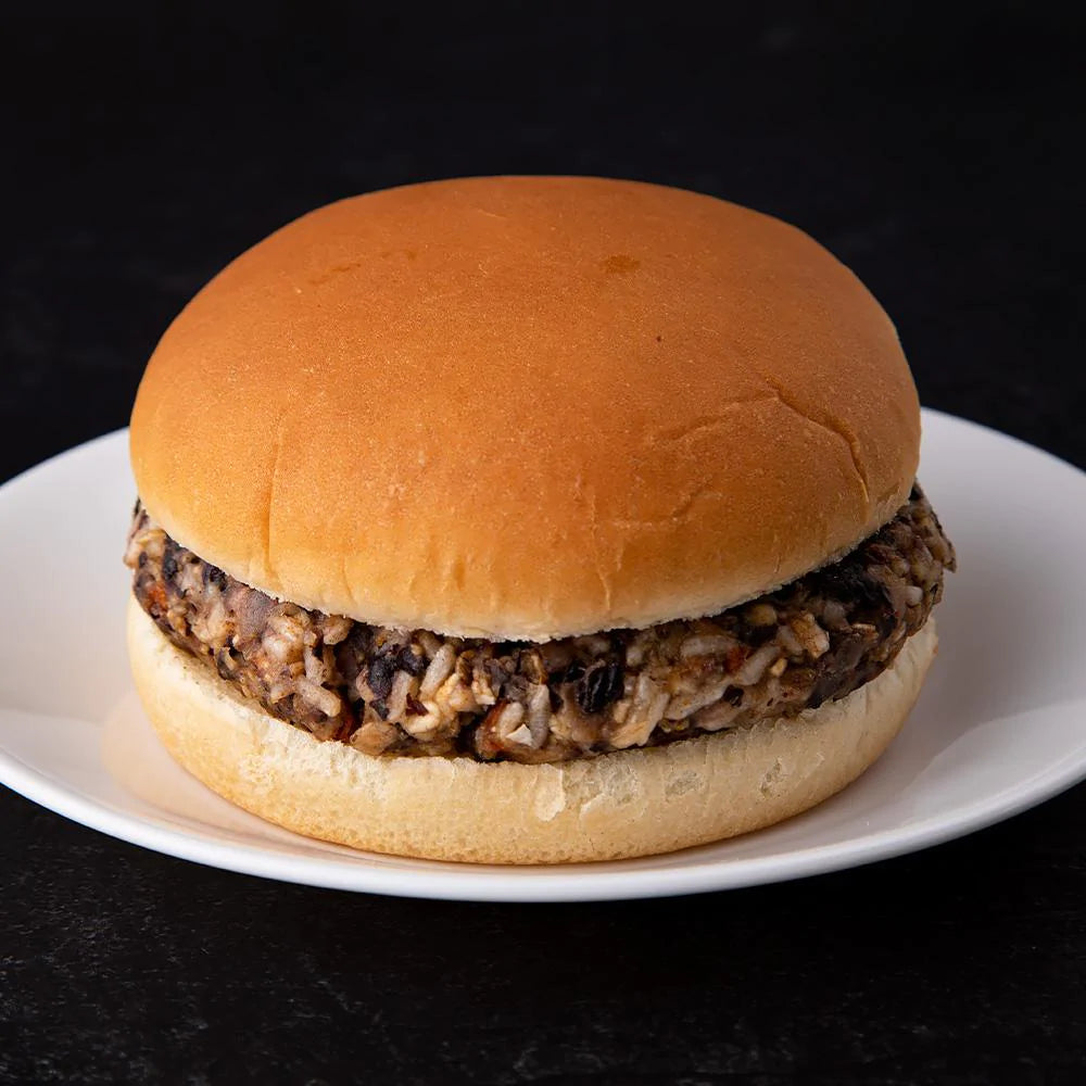 ready hour black bean burger patty on bun on white plate 